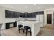 Modern kitchen featuring black cabinets, a center island with seating, and stainless steel appliances at 12618 E 86Th St, Indianapolis, IN 46236