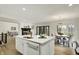 Open-concept kitchen with island, granite countertops, seamless flow into the dining area and living room at 12618 E 86Th St, Indianapolis, IN 46236
