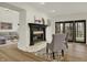 Bright living room featuring a fireplace and view to outdoor patio at 12618 E 86Th St, Indianapolis, IN 46236
