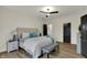 Comfortable main bedroom with a stylish bed, bench, and easy access to adjoining rooms through dark paneled doors at 12618 E 86Th St, Indianapolis, IN 46236