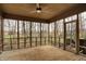 Relaxing screened porch showcases a ceiling fan and a serene view of the surrounding nature at 12618 E 86Th St, Indianapolis, IN 46236