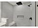 Modern tiled shower featuring rainfall shower head, handheld sprayer, and convenient built-in bench at 12618 E 86Th St, Indianapolis, IN 46236