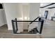 Modern stairwell featuring black metal railings and wood-look floors, transitioning to the living area at 12618 E 86Th St, Indianapolis, IN 46236