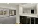 Stylish wet bar area with wine fridge, quartz counters, and glass doors to the patio at 12618 E 86Th St, Indianapolis, IN 46236