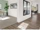 Open hallway with views into the dining area and study, featuring modern flooring at 1281 Sika Ln, Greenwood, IN 46143