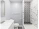 Stylish bathroom featuring marble style walls, mosaic tile accent and modern fixtures at 1302 S Sherman Dr, Indianapolis, IN 46203