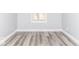 Bright bedroom featuring new wood-style flooring and a window for natural light at 1302 S Sherman Dr, Indianapolis, IN 46203
