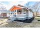 Charming bungalow featuring a well-manicured lawn and covered front porch, perfect for enjoying the outdoors at 1302 S Sherman Dr, Indianapolis, IN 46203