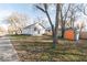 Charming home exterior with a well-maintained lawn, shed and mature trees at 1302 S Sherman Dr, Indianapolis, IN 46203