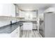 Modern kitchen featuring white cabinets, sleek countertops, and stainless steel appliances for a stylish cooking space at 1302 S Sherman Dr, Indianapolis, IN 46203