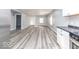 Spacious living area featuring gray flooring and an open layout, flowing seamlessly into a modern kitchen at 1302 S Sherman Dr, Indianapolis, IN 46203