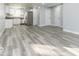 Inviting living area with gray wood-look flooring, connecting seamlessly to the modern, well-equipped kitchen at 1302 S Sherman Dr, Indianapolis, IN 46203