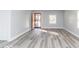 Bright living room with modern gray wood-look flooring and neutral walls, creating a serene atmosphere at 1302 S Sherman Dr, Indianapolis, IN 46203