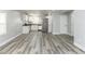 Open-concept living space featuring sleek gray floors and abundant natural light, perfect for modern living at 1302 S Sherman Dr, Indianapolis, IN 46203