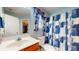 Bright bathroom with walk-in closet, modern vanity, and decorative shower curtain at 1304 Vicksburg S Dr, Greenwood, IN 46143