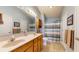 Well-lit bathroom with double sinks, wood cabinets, and a shower-tub combination at 1304 Vicksburg S Dr, Greenwood, IN 46143