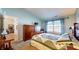 Bright bedroom featuring a large dresser, a TV, a comfortable quilt, and natural light at 1304 Vicksburg S Dr, Greenwood, IN 46143