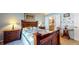 Comfortable bedroom with hardwood furniture, warm lighting and an en-suite bathroom at 1304 Vicksburg S Dr, Greenwood, IN 46143