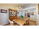 Cozy dining area with a dining table set for six next to an open kitchen at 1304 Vicksburg S Dr, Greenwood, IN 46143