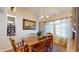 Light-filled dining room with wood table, chandelier, and decorative wall art at 1304 Vicksburg S Dr, Greenwood, IN 46143