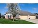Beautiful home with a large tree in the front yard and a three-car garage at 1304 Vicksburg S Dr, Greenwood, IN 46143