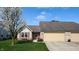 Charming single-story home with attached garage, landscaped lawn, and flowering tree at 1304 Vicksburg S Dr, Greenwood, IN 46143