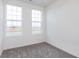 Bright bedroom with two windows offering views of the surrounding landscape at 14539 Hanford Ln, Carmel, IN 46032