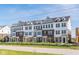 Attractive townhome complex with brick and siding, accented by green grass, trees, and a rustic wood fence at 14539 Hanford Ln, Carmel, IN 46032