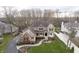 An aerial view of a tan home with well-maintained landscaping, a winding walkway, and a lush green lawn at 14577 Faucet Ln, Fishers, IN 46040