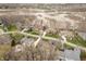 High-angle view of a quiet neighborhood with several homes and a floodplain in the background at 14577 Faucet Ln, Fishers, IN 46040