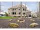 Backyard with a fire pit and patio, surrounded by mature trees and landscaping at 14577 Faucet Ln, Fishers, IN 46040