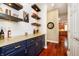 Stylish bar area with floating shelves, a wine cooler, and custom cabinetry at 14577 Faucet Ln, Fishers, IN 46040