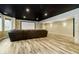 Basement home theater with a projector screen, black ceiling, and comfortable leather seating at 14577 Faucet Ln, Fishers, IN 46040
