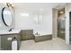 Bright bathroom features shiplap walls, a built-in tub, sleek fixtures, and a separate shower, creating a spa-like retreat at 14577 Faucet Ln, Fishers, IN 46040