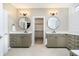 Dual vanities offer lots of storage and prep space and are separated by an entrance to the walk-in closet at 14577 Faucet Ln, Fishers, IN 46040