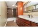 Bathroom with marble countertop, dark wood cabinets, and tiled shower/tub combination at 14577 Faucet Ln, Fishers, IN 46040