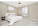 Bedroom featuring neutral walls and carpet, a bed, end tables, and natural light from large windows at 14577 Faucet Ln, Fishers, IN 46040