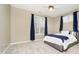 Comfortable bedroom features a bed, ceiling fan, neutral walls and carpet, and natural light from large windows at 14577 Faucet Ln, Fishers, IN 46040