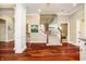 Open foyer featuring hardwood floors, decorative columns, staircase access, and a view of the upstairs landing at 14577 Faucet Ln, Fishers, IN 46040