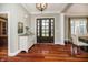 Inviting foyer with hardwood floors, a decorative chandelier, and a view into the adjoining office and dining area at 14577 Faucet Ln, Fishers, IN 46040