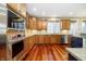 Modern kitchen showcasing stainless steel appliances, ample cabinet space, and quartz countertops at 14577 Faucet Ln, Fishers, IN 46040