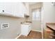 Bright laundry room featuring ample cabinet space, a sink, and a window with natural light at 14577 Faucet Ln, Fishers, IN 46040