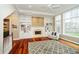 Cozy living room with built-in shelving surrounding the fireplace and a beautiful view of the backyard at 14577 Faucet Ln, Fishers, IN 46040