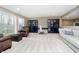 Open living room features a seating area, large windows, and built-in shelving with a desk at 14577 Faucet Ln, Fishers, IN 46040