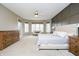 Large primary bedroom suite with tray ceiling, sitting area, and lots of natural light at 14577 Faucet Ln, Fishers, IN 46040