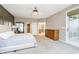 Bright primary bedroom offers a tray ceiling, a ceiling fan, and access to a private balcony at 14577 Faucet Ln, Fishers, IN 46040