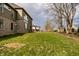 Backyard featuring lush green grass, a brick and siding house exterior, and a gently sloping hill at 14818 Autumn View Way, Fishers, IN 46037