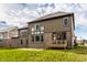 Backyard featuring green grass, a two-story house exterior, a wooden deck, and blue sky with clouds at 14818 Autumn View Way, Fishers, IN 46037