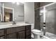 Well-lit bathroom featuring a stylish vanity, toilet, and a modern shower with glass doors at 14818 Autumn View Way, Fishers, IN 46037