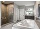 Luxurious bathroom featuring a standalone tub, walk-in shower, and double vanity, creating a spa-like retreat at 14818 Autumn View Way, Fishers, IN 46037